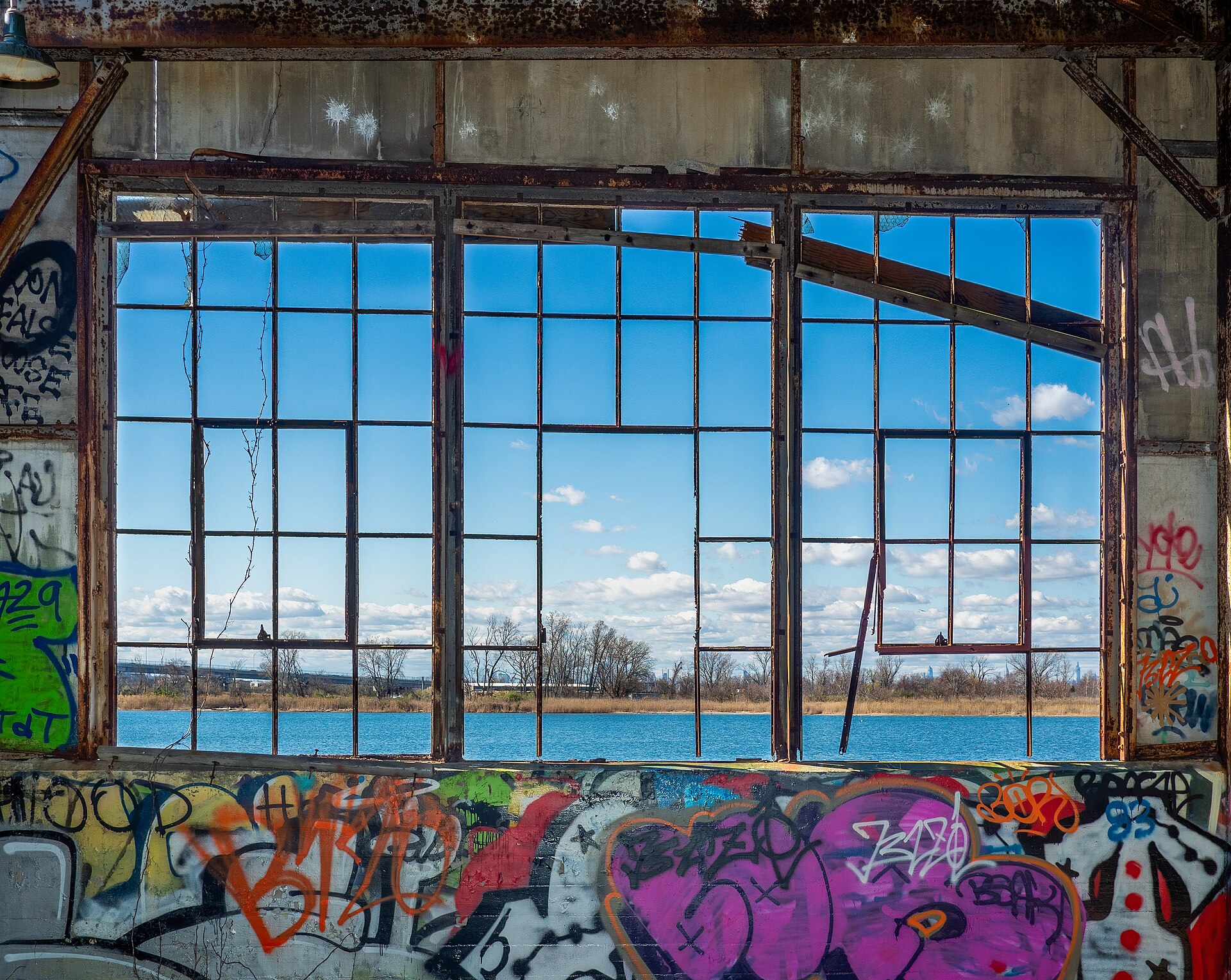 A derelict building window frames a waterfront view, representing the potential for new beginnings in content creation.