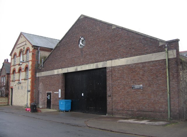 RAF Sculthorpe | Online Stars A brick building with a horse emblem, RAF Sculthorpe, serves as a location for digital creator resources.